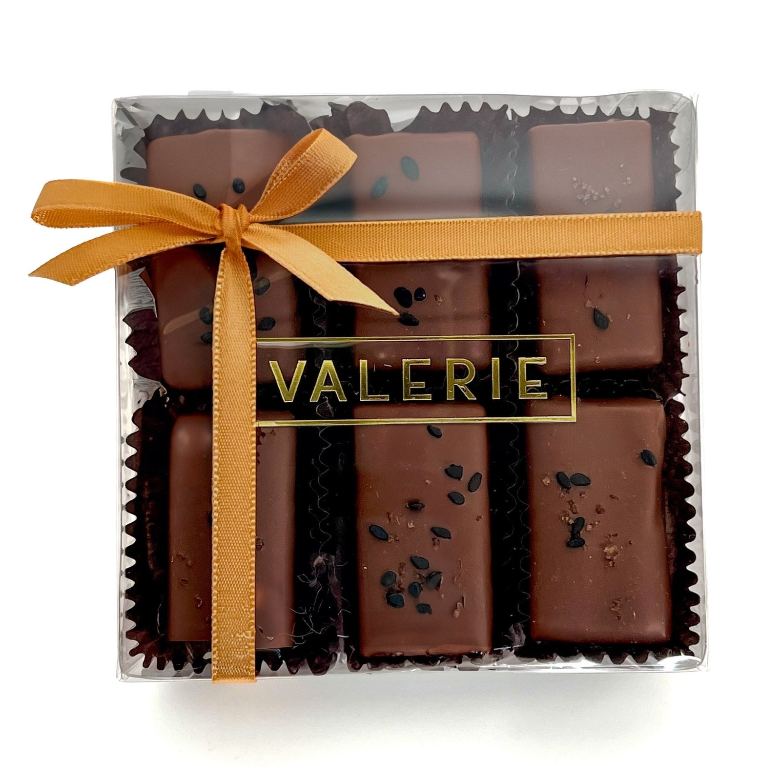 box of Rice & Sesame Caramels from Valerie Confections, featuring chocolate-covered caramels topped with black sesame seeds and soy salt, wrapped in an elegant golden ribbon.