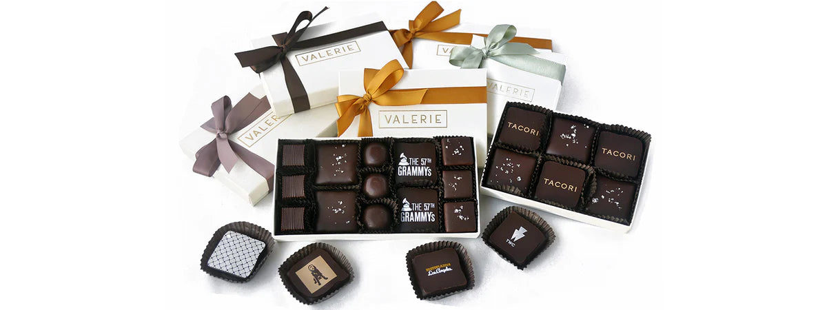 Assorted chocolate truffles and gift boxes with visible branding on a white background