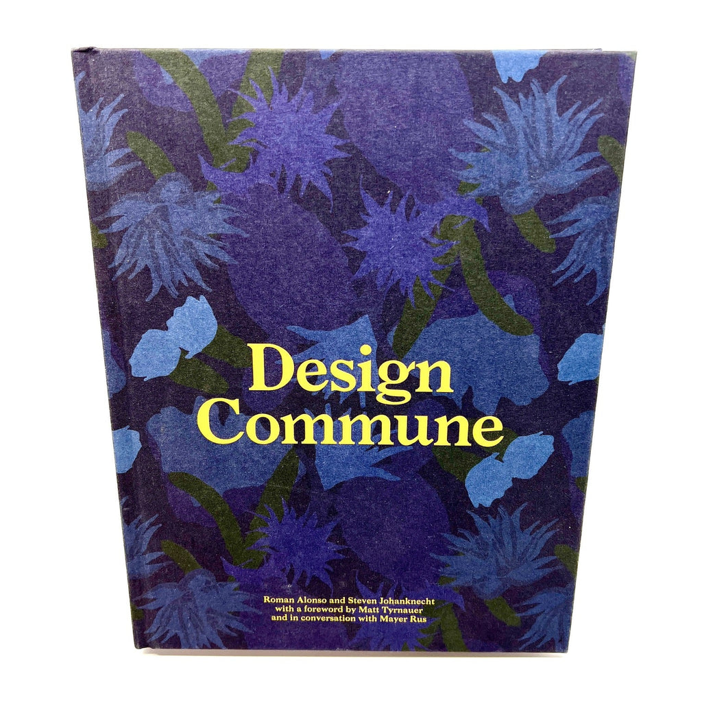 The cover of 'Design Commune,' a visually striking book featuring bold floral artwork in shades of blue and green, with yellow typography. This book showcases the creative philosophy and design approach of Commune.