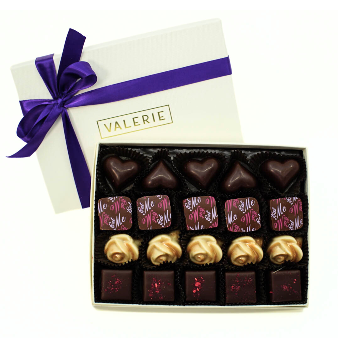 A beautifully wrapped Easter Truffle Assortment gift box, adorned with a rich amethyst satin ribbon, perfect for holiday gifting.