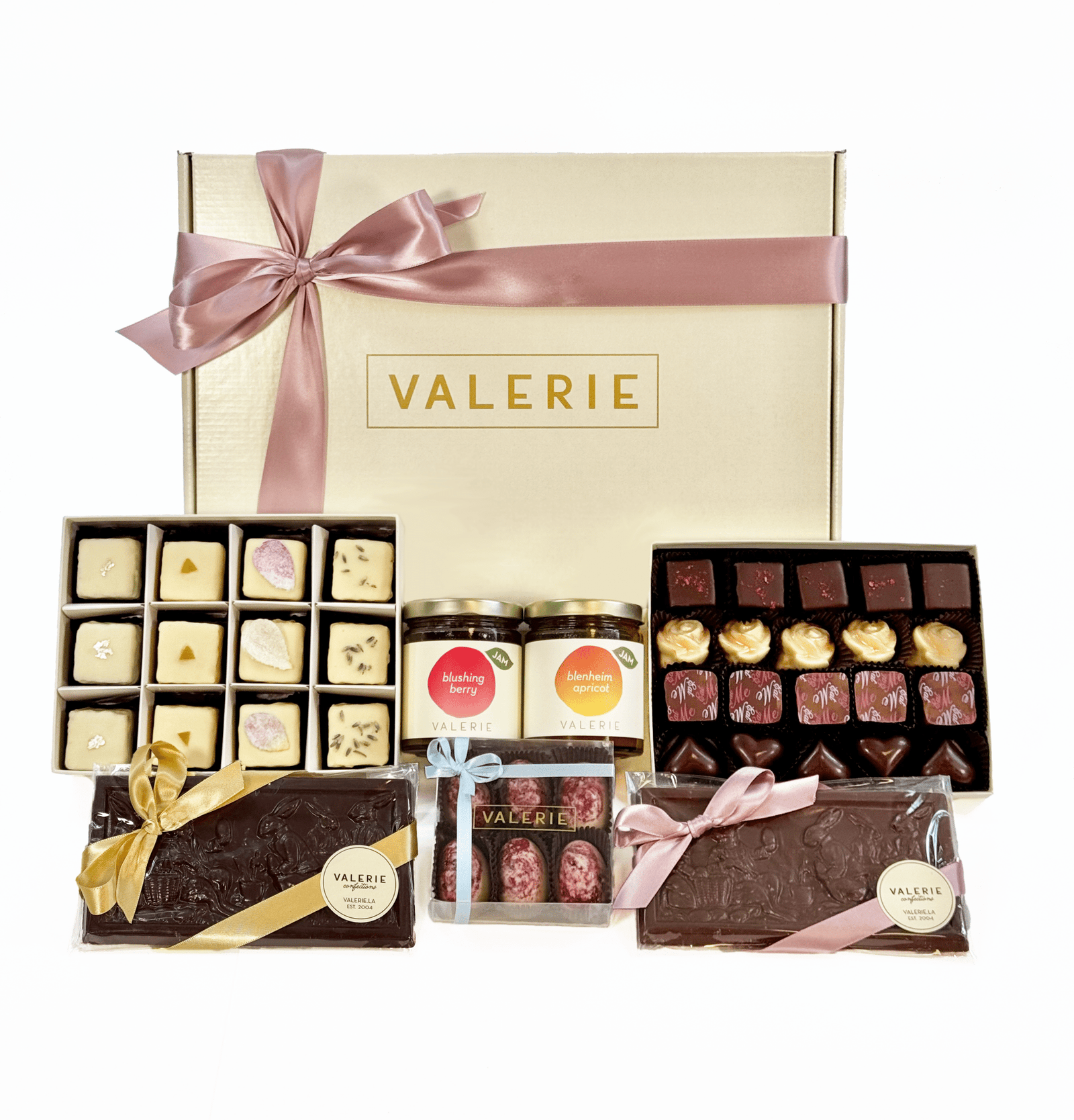 A beautifully arranged Extravagant Easter Gift Set from Valerie Confections, featuring handmade chocolates, petits fours, seasonal jams, and Bunny Tableau Bars, all elegantly packaged with a satin ribbon.