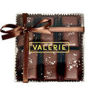 A box of Fleur de Sel Caramels from Valerie Confections, featuring chocolate-covered almond-studded caramels sprinkled with delicate sea salt and tied with an elegant brown satin ribbon.