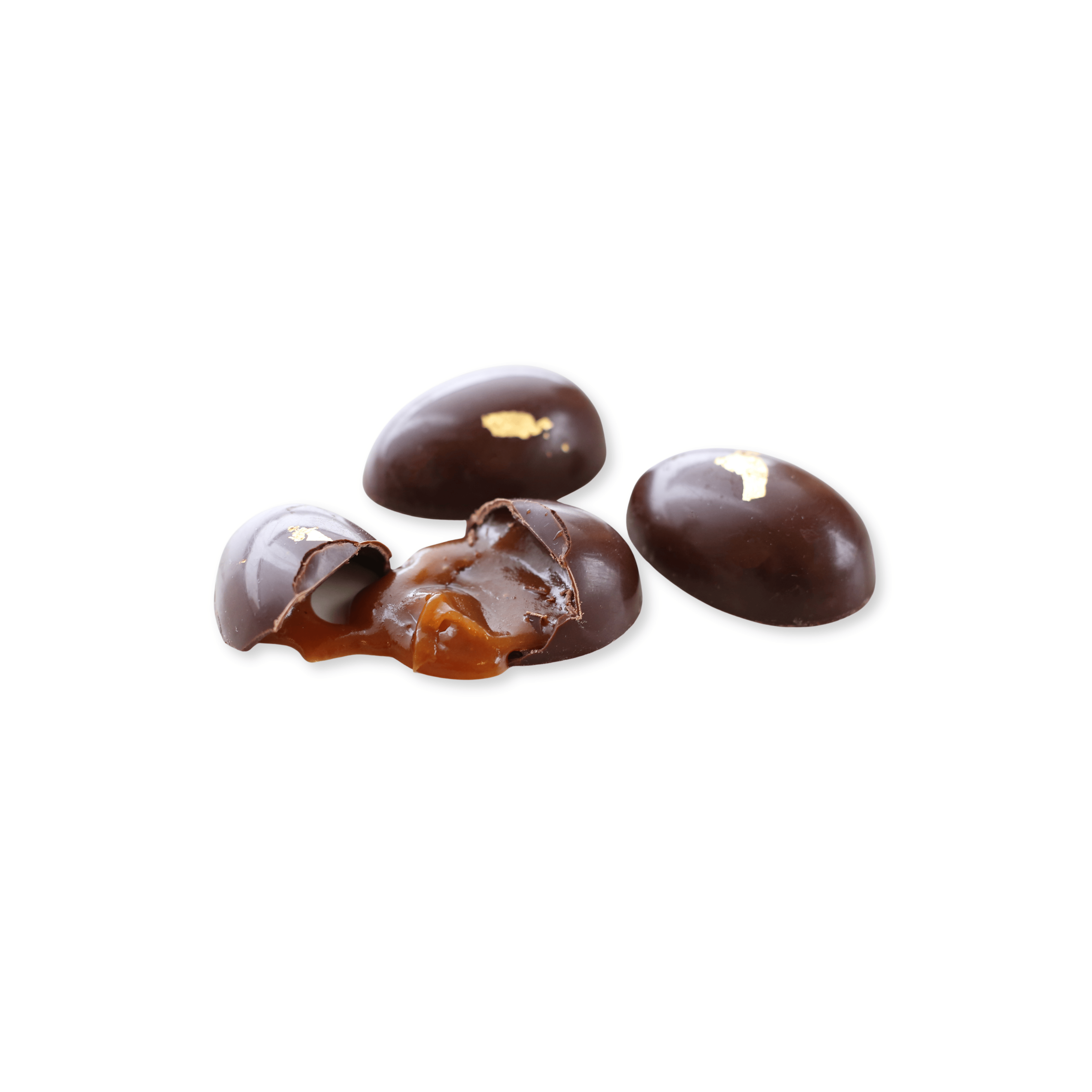 Chocolate eggs with a visible caramel filling on a white background