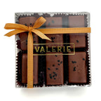 box of Rice & Sesame Caramels from Valerie Confections, featuring chocolate-covered caramels topped with black sesame seeds and soy salt, wrapped in an elegant golden ribbon.