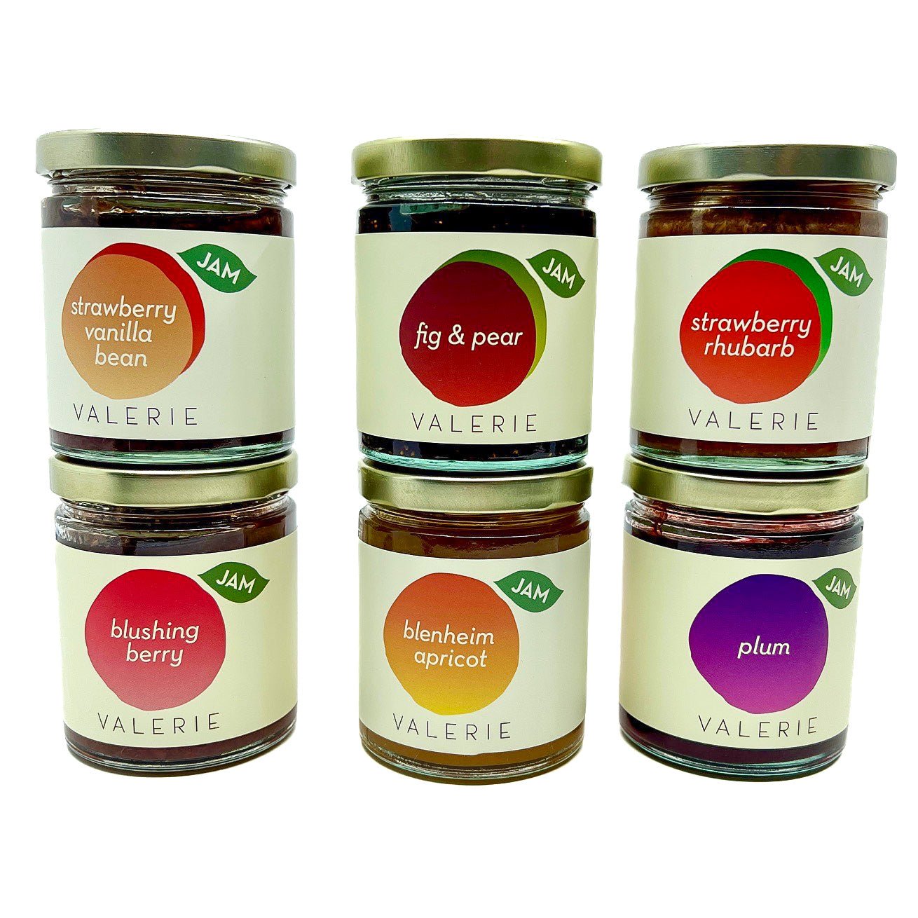 A curated set of six jars of handcrafted Valerie Confections jams, featuring seasonal flavors: Blenheim Apricot, Strawberry Vanilla Bean, Plum, Fig & Pear, Blushing Berry, and Strawberry Rhubarb.