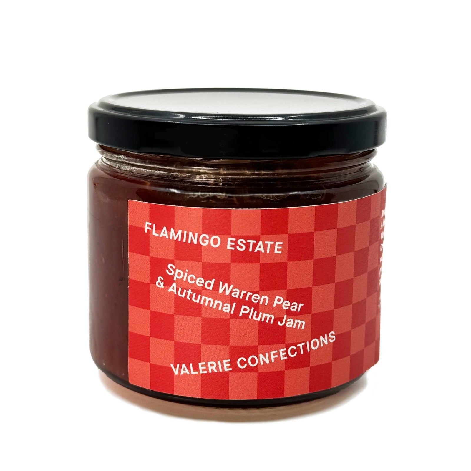 A glass jar of Spiced Warren Pear & Autumnal Plum Jam from Valerie Confections in collaboration with Flamingo Estate. The jam is packaged in a red checkered label with elegant white typography