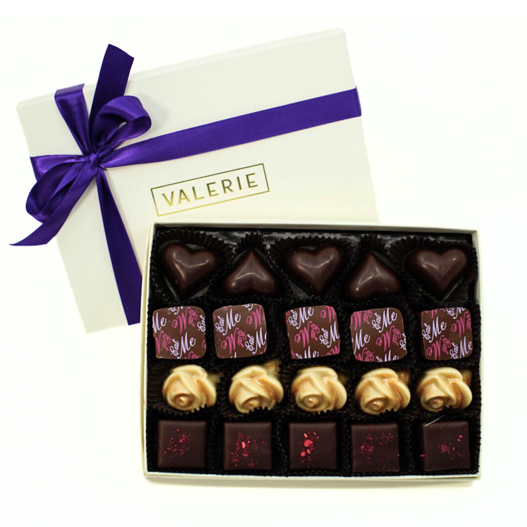  Rectangular box of chocolates with a purple ribbon and label &quot;VALERIE&quot;.