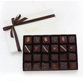 A luxurious 24-piece box of handcrafted assorted toffees dipped in bittersweet chocolate, elegantly presented in an ivory gift box with a brown satin ribbon.