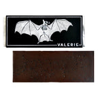 A 72% bittersweet chocolate bar with black lava salt, unwrapped and displayed with its bat-themed packaging.