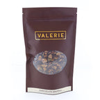 A sealed Valerie Confections chocolate granola bag with a clear window showing the granola mix inside.