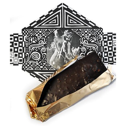 An unwrapped GOOD MIX BAR, revealing dark chocolate with embedded almonds, cocoa nibs, and seeds, next to its artistic, vintage-inspired packaging.