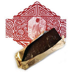 HOT GOOD MIX BAR partially unwrapped from gold foil, revealing its rich dark chocolate and textured ingredients.