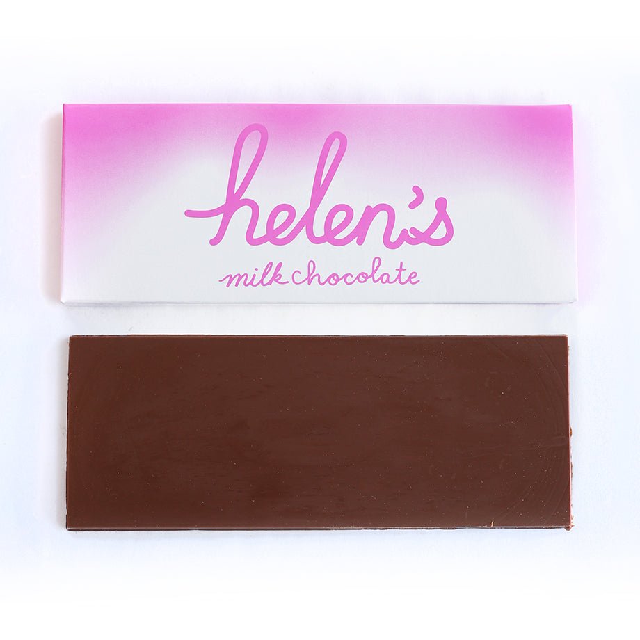 A Helen’s Milk Chocolate Bar, featuring a smooth milk chocolate bar placed next to its pink and white packaging with elegant script branding.