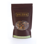 A brown resealable bag of Valerie Confections House Granola, labeled with ingredients and ready for gifting or enjoying at home.