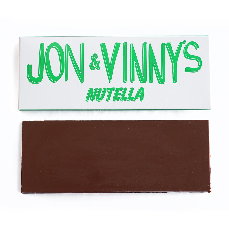 A Jon & Vinny's Nutella Chocolate Bar, featuring a smooth milk chocolate bar placed next to its green and white branded packaging.