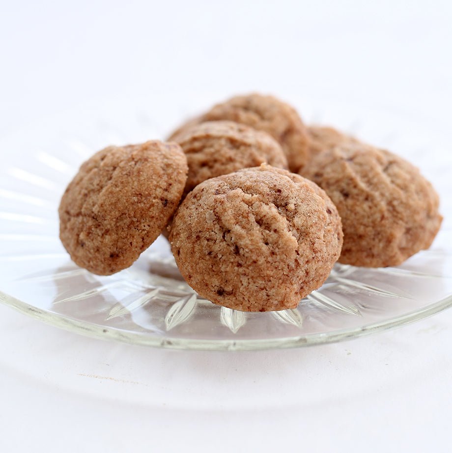 A plate of golden-brown Malted Shortbread Cookies by Valerie Confections, showcasing their delicate crumb and rich, buttery texture.