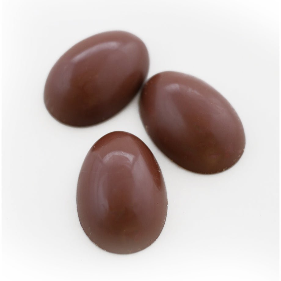 Three smooth, milk chocolate ganache eggs displayed on a white background.