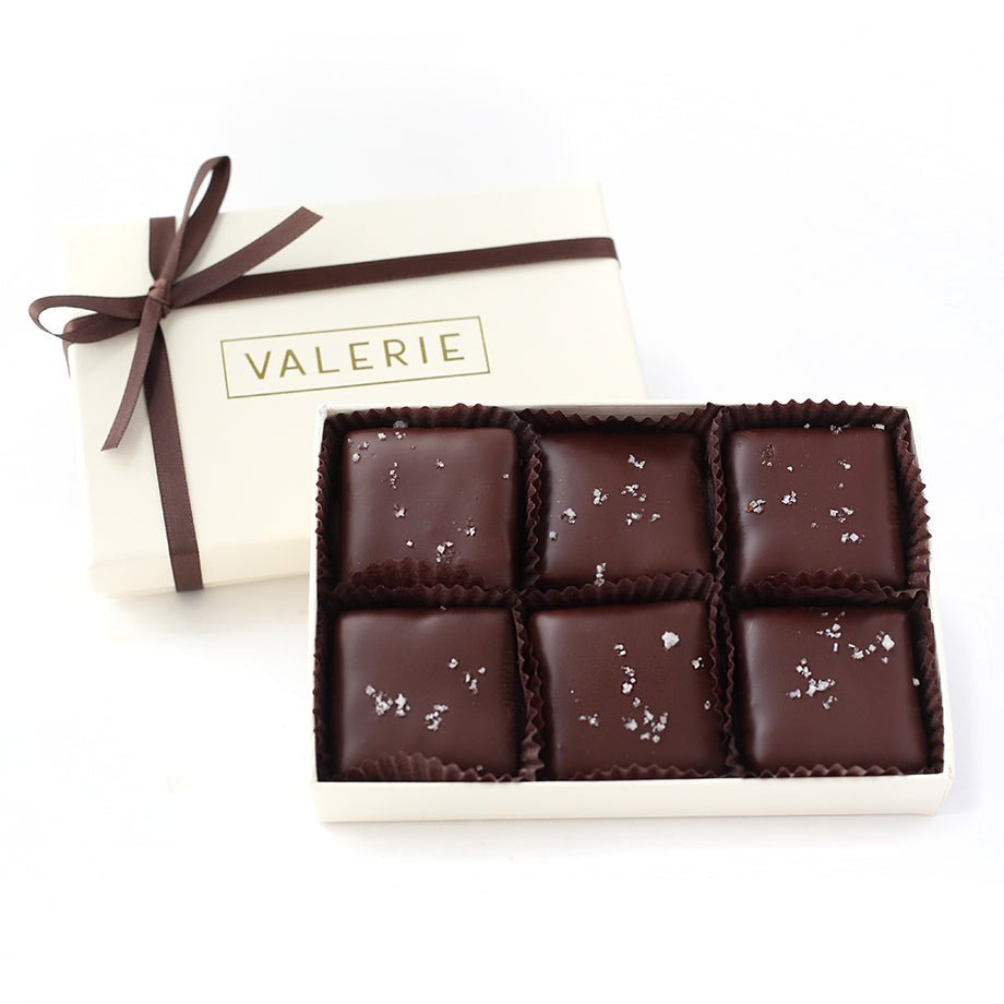 6 pieces of Almond Fleur de Sel chocolate covered toffees, in a small ivory Valerie box with thin chocolate brown satin ribbon.
