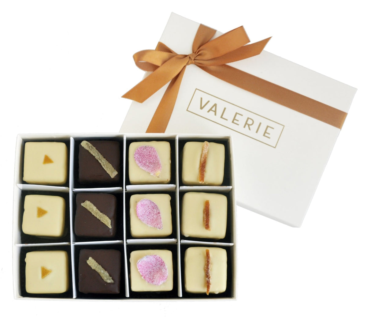 Box of twelve petits fours with decorative toppings and a white lid with a gold ribbon, labeled &quot;VALERIE&quot;.