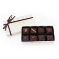 A luxurious 8-piece assortment of handcrafted bittersweet chocolate toffee, elegantly packaged in an ivory gift box with a brown satin ribbon.