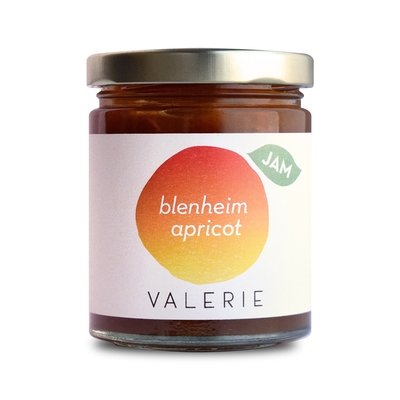 Glass jar of Valerie Blenheim Apricot jam with a white label.