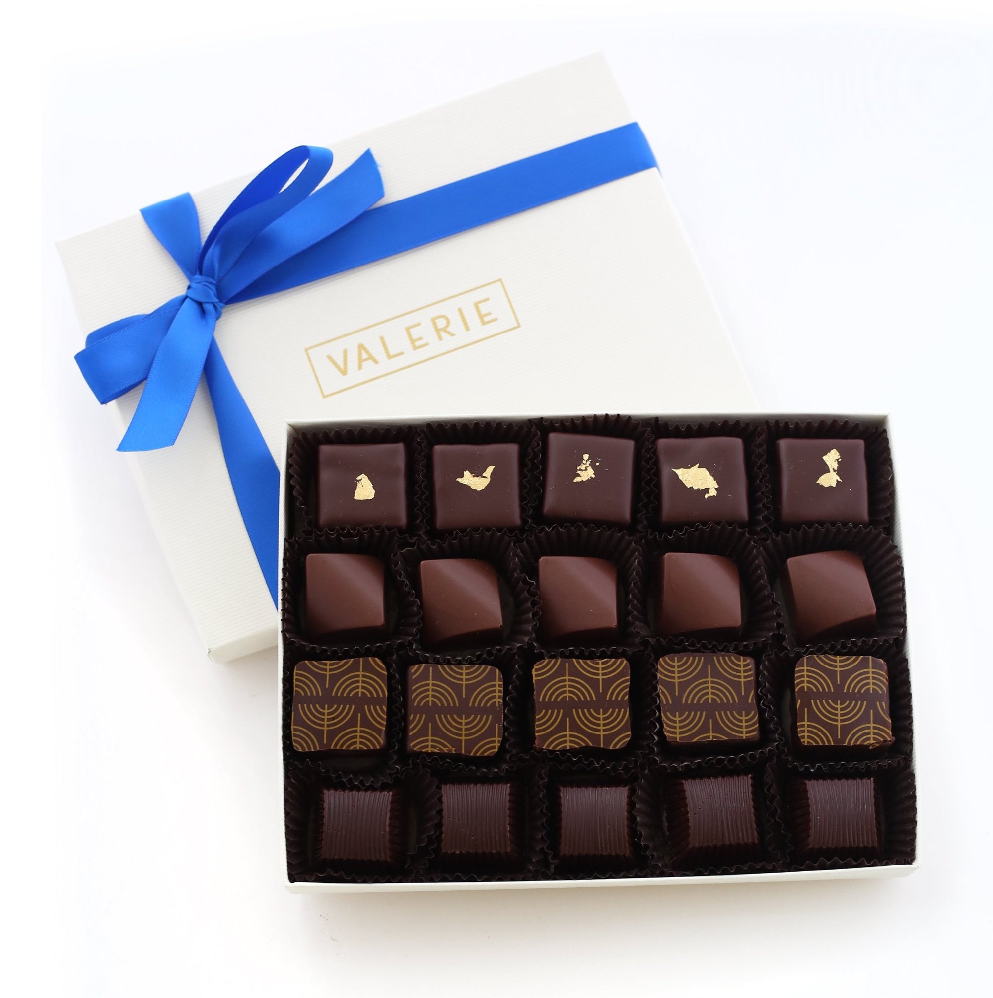  A box of assorted chocolates with a blue ribbon and the word "VALERIE" on the lid.