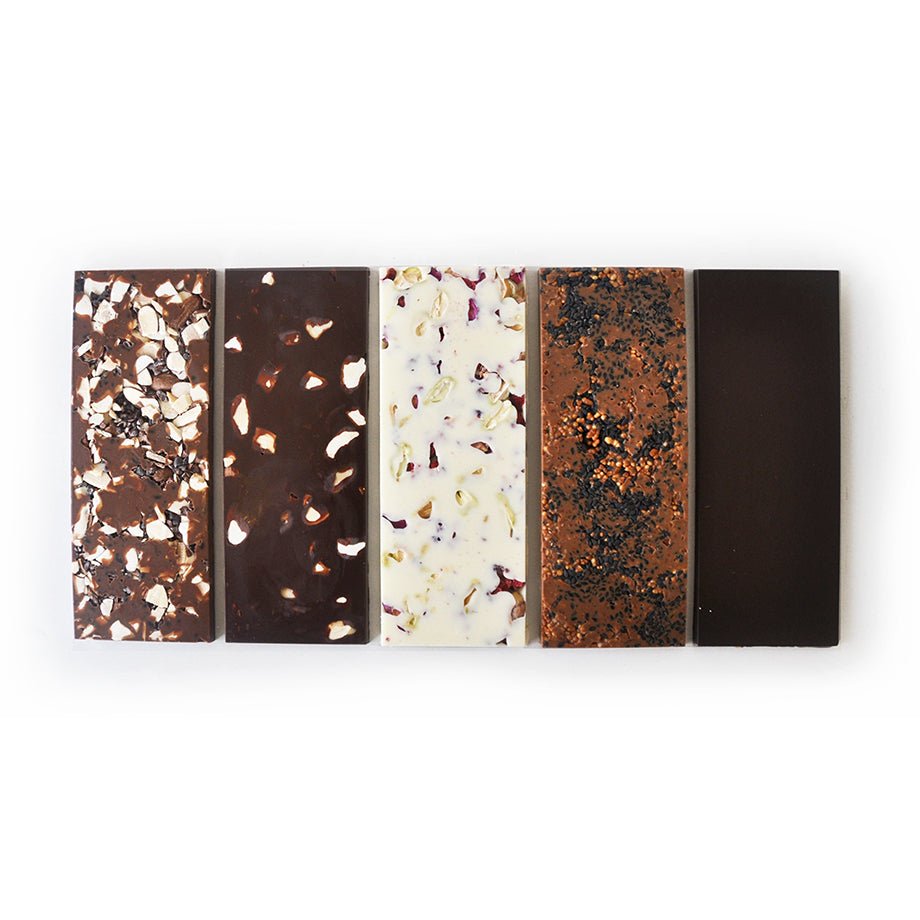 A set of five distinct chocolate bars with various ingredients and appearances arranged in a horizontal row.