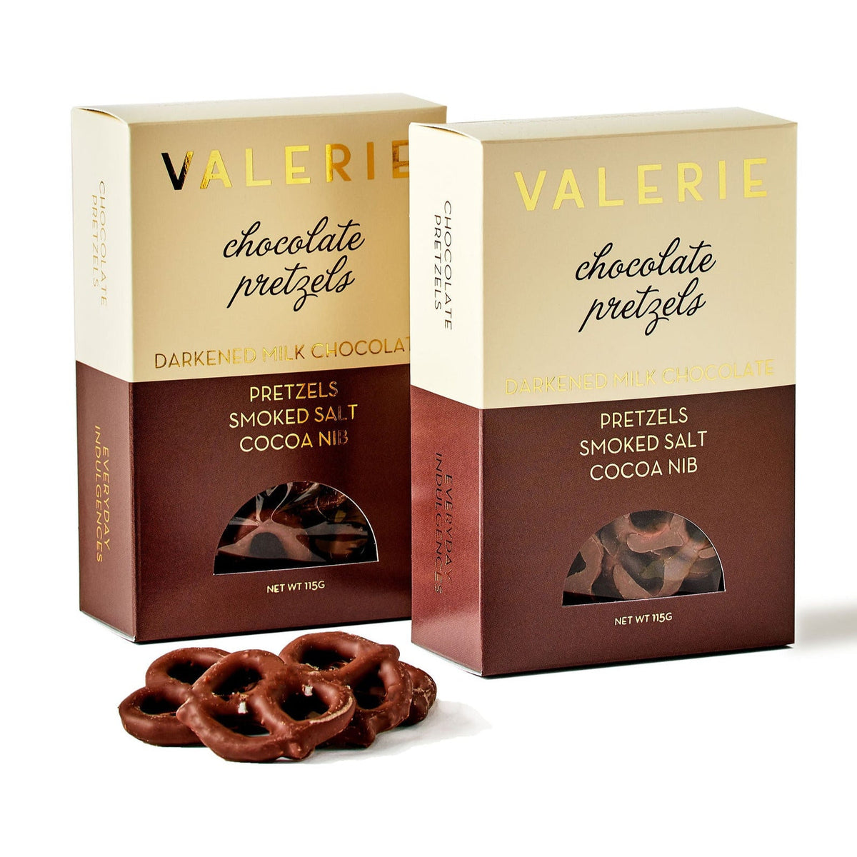 Two boxes of Valerie chocolate pretzels and handful of loose chocolate-covered pretzels.