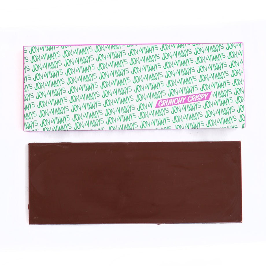 Chocolate bar labeled &quot;JON &amp; VINNYS CRUNCHY CRISPY&quot; with smooth brown surface.