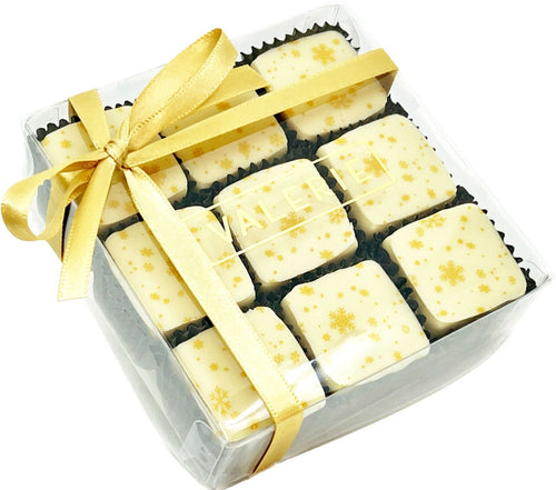Box of twelve square eggnog truffles decorated with golden snowflakes, tied with a golden ribbon.