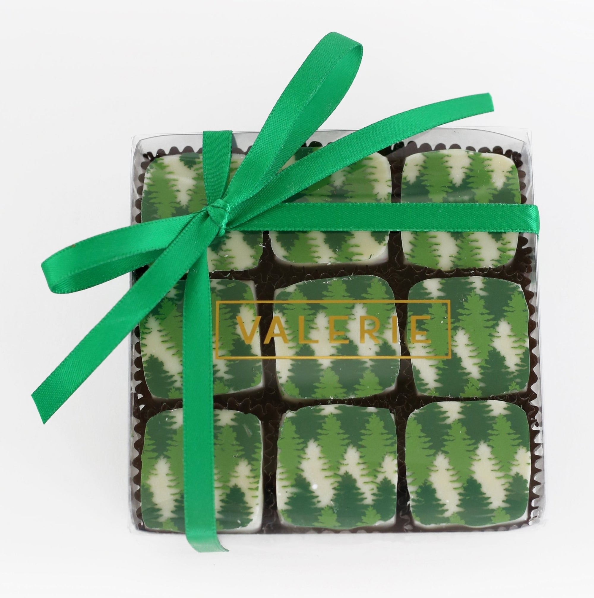 Box of nine chocolates with green tree patterns, wrapped with a green ribbon and labeled "VALERIE."