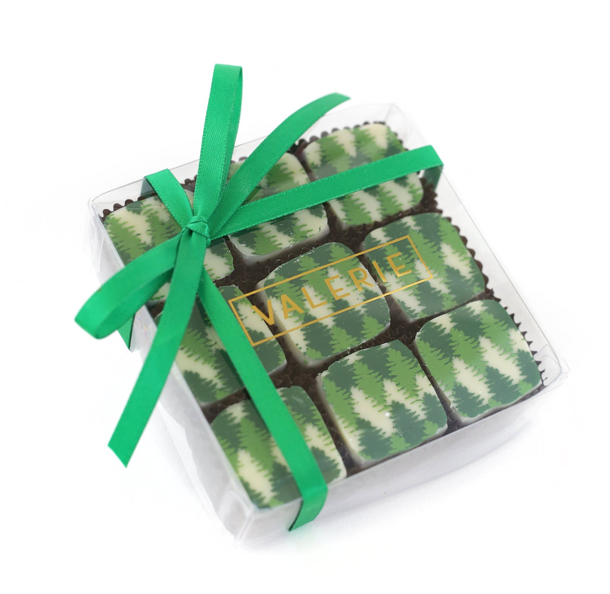 Box of nine chocolates with green tree patterns, wrapped with a green ribbon and labeled &quot;VALERIE.&quot;