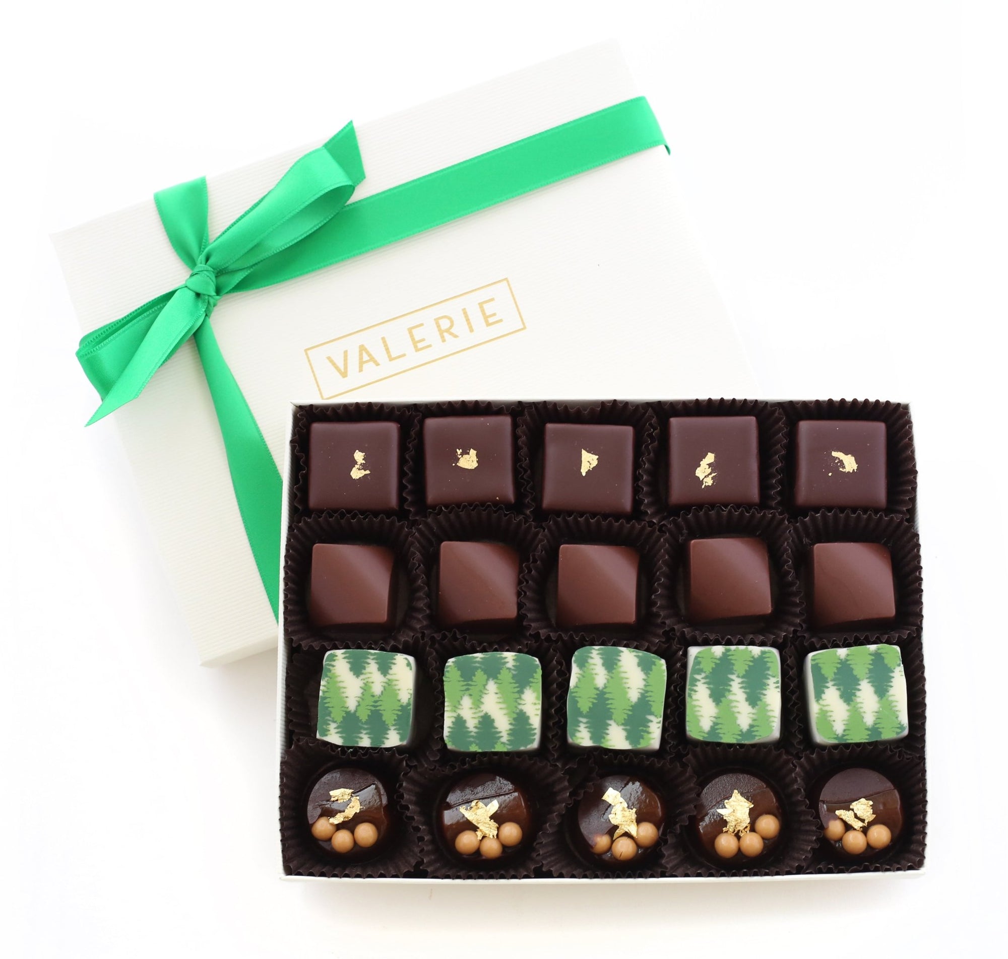 Assorted chocolates in a white box with a green ribbon and "VALERIE" printed in gold on the lid.