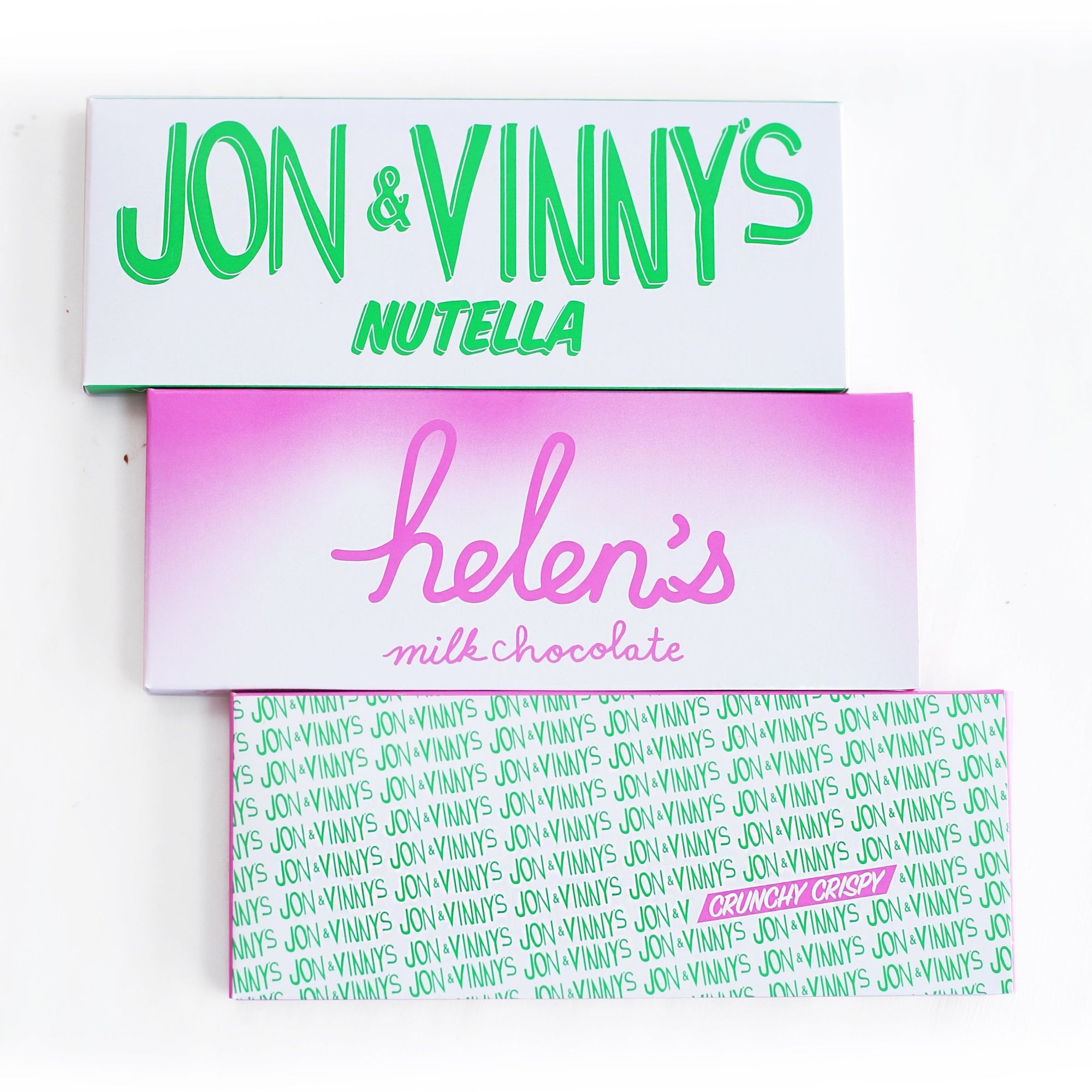  Three chocolate bar wrappers from Jon & Vinny and Helen and Valerie Milk Chocolate Bar Gift Set. From top to bottom: "JON & VINNY'S NUTELLA" in green on white, "helen's milk chocolate" in pink on a pink-to-white gradient, and "JON & VINNY'S CRUNCHY CRISPY" in green on white with a pink highlight.