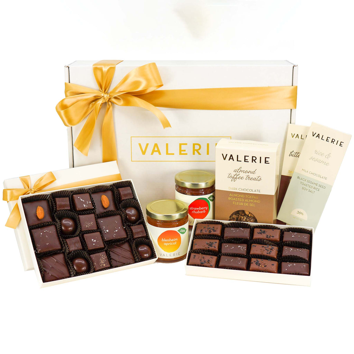  Gift box with assorted Valerie chocolates, toffee treats, and preserve jars, tied with a golden ribbon.