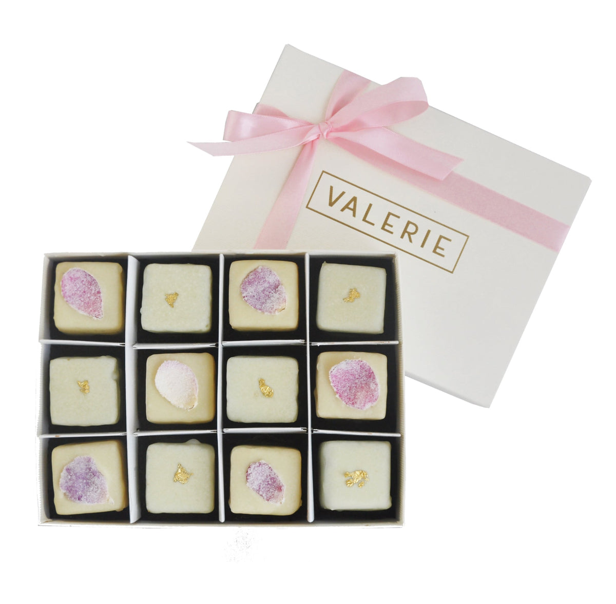 Box of 12 petits fours, six with rose petals and six with gold leaf, in a white box with a pink ribbon and “VALERIE” printed on the lid.
