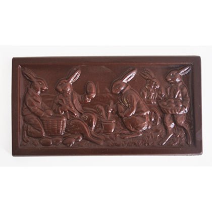 Rectangular chocolate bar with an Easter scene of five rabbits engaged in activities such as holding baskets.