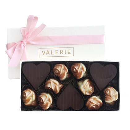 Box of assorted chocolates with heart-shaped and rose designs, labeled "VALERIE."